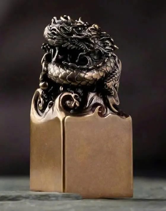 Bronze seal with a dragon rising from clouds