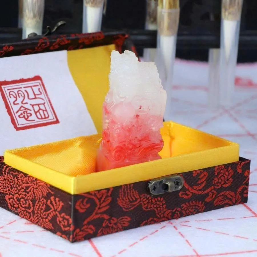 Red and white jade seal in a brocade box